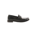 Side view of black leather Saint Laurent penny loafer with YSL monogram detail and low stacked heel on a white background.