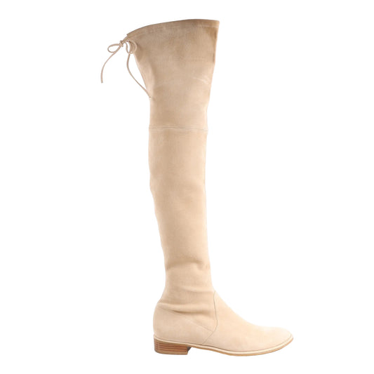 Stuart Weitzman Lowland Over The Knee Boot in beige suede, size 39.5 EU, featuring a stretch fit, tie-back closure at the top, low stacked heel, and sleek almond toe, displayed against a white background.