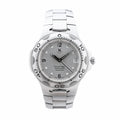 TAG Heuer Kirium stainless steel watch with silver dial, black hands, date window, numbered bezel and integrated steel bracelet.