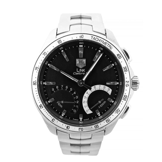 Close-up of a TAG Heuer Link Calibre S CAT7010 watch featuring a black dial with vertical striping, silver-tone hour markers, two sub-dials, tachymeter bezel, and stainless steel bracelet.