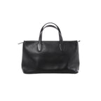 Black The Row Marcel leather bag with smooth finish, elongated double handles, softly structured rectangular shape and minimal detailing.
