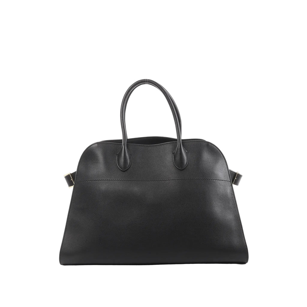 Black The Row Soft Margaux 15 leather handbag with rounded top, double top handles, and small side buckle details with gold-tone hardware.