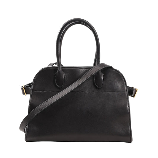 Front view of The Row Soft Margaux 10 handbag in black smooth leather featuring a structured yet soft silhouette, dual top handles, and a detachable shoulder strap with gold-tone hardware.