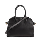 Front view of The Row Soft Margaux 10 handbag in black smooth leather featuring a structured yet soft silhouette, dual top handles, and a detachable shoulder strap with gold-tone hardware.