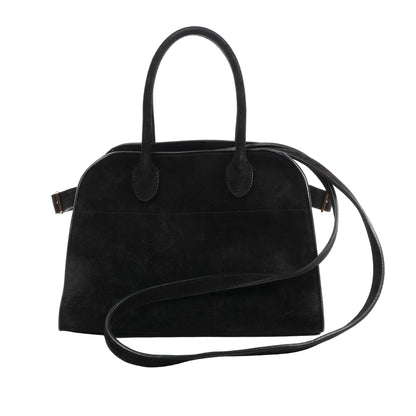 The Row Soft Margaux 10 2Way Handbag in black suede with curved top handles, long shoulder strap, and structured silhouette, displayed against a white background.