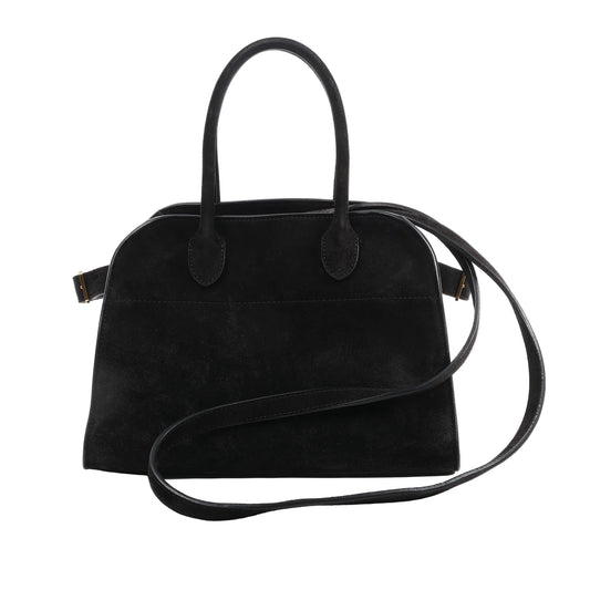 The Row Soft Margaux 10 2Way Handbag in black suede with curved top handles, long shoulder strap, and structured silhouette, displayed against a white background.