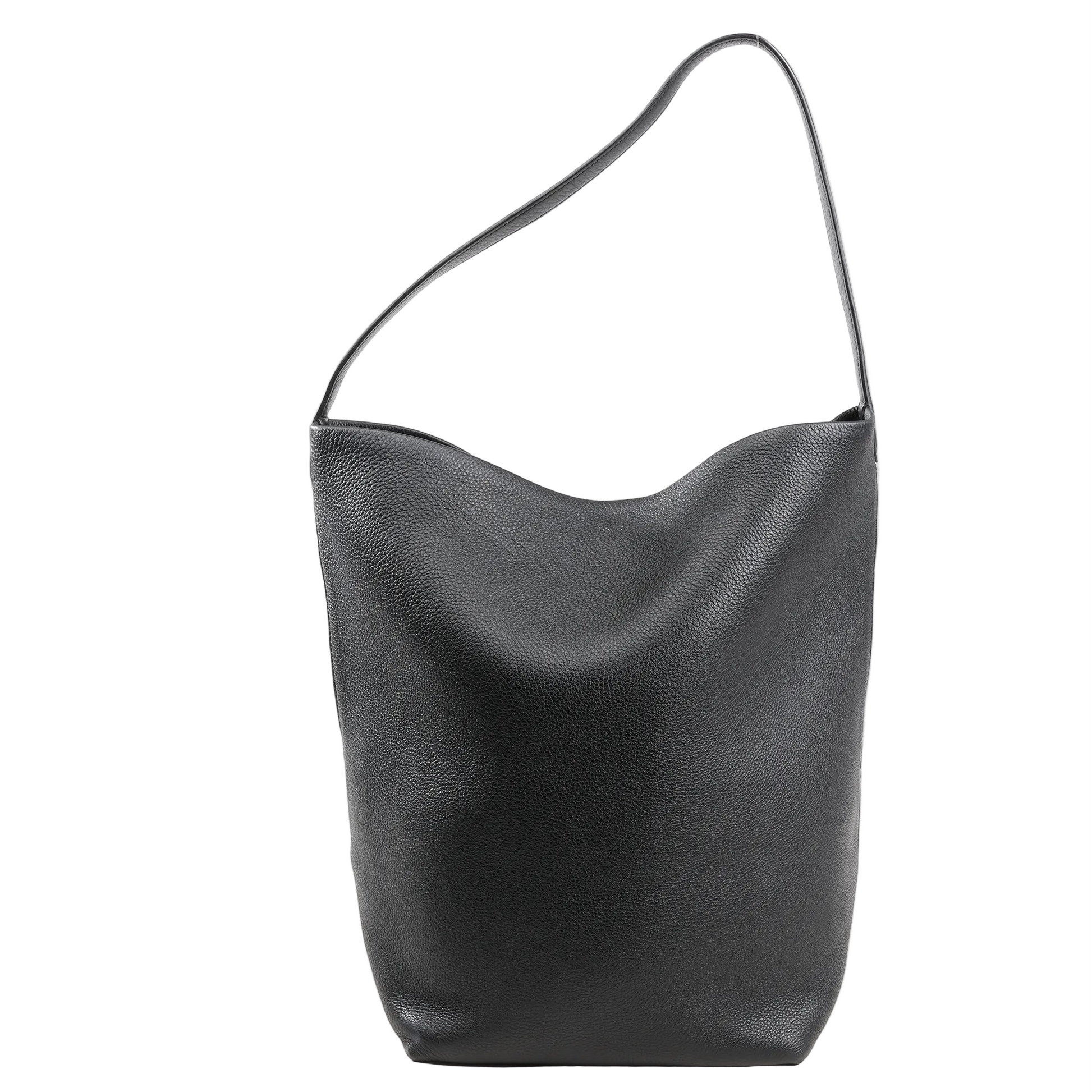 The Row Park Tote Medium Shoulder Bag in black grained leather with a slouchy silhouette, single flat shoulder strap, and unstructured minimalist design on a white background.