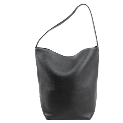 The Row Park Tote Medium Shoulder Bag in black grained leather with a slouchy silhouette, single flat shoulder strap, and unstructured minimalist design on a white background.