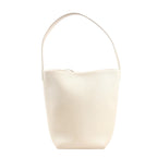 The Row Park Tote Small shoulder bag in ecru grained leather featuring a curved, unstructured silhouette, single wide strap, and minimalist design without visible hardware.