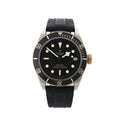 Front view of Tudor Black Bay S&G watch with black rubber strap, black dial with luminous hour markers, snowflake hands, black bezel with minute scale, gold-tone crown, and date window at 3.