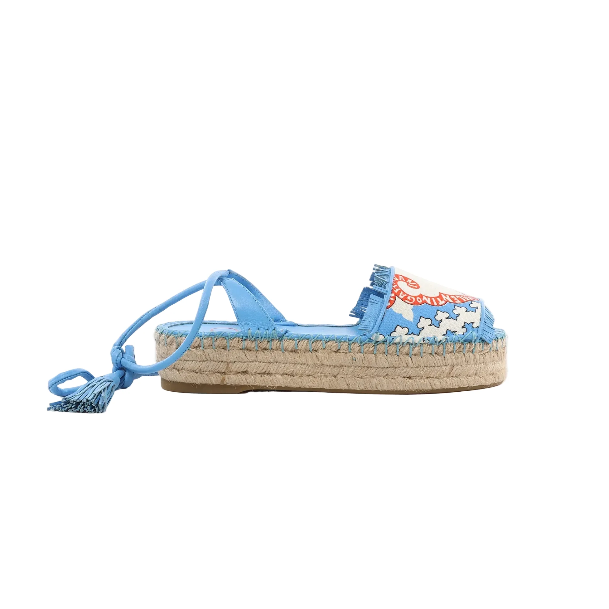 Blue Valentino Garavani espadrille sandal with rope platform sole, printed canvas strap with fringe, and lace-up ankle ties with tassels.
