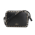 Valentino Garavani Rockstud Crossbody Bag in black leather with gold-tone pyramid stud trim, adjustable shoulder strap, and gold logo detail, displayed against a white background.