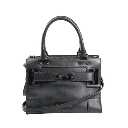 Valentino Garavani Rockstud handbag in smooth black leather with top handles, adjustable shoulder strap, and gunmetal stud detailing on the front and corners.