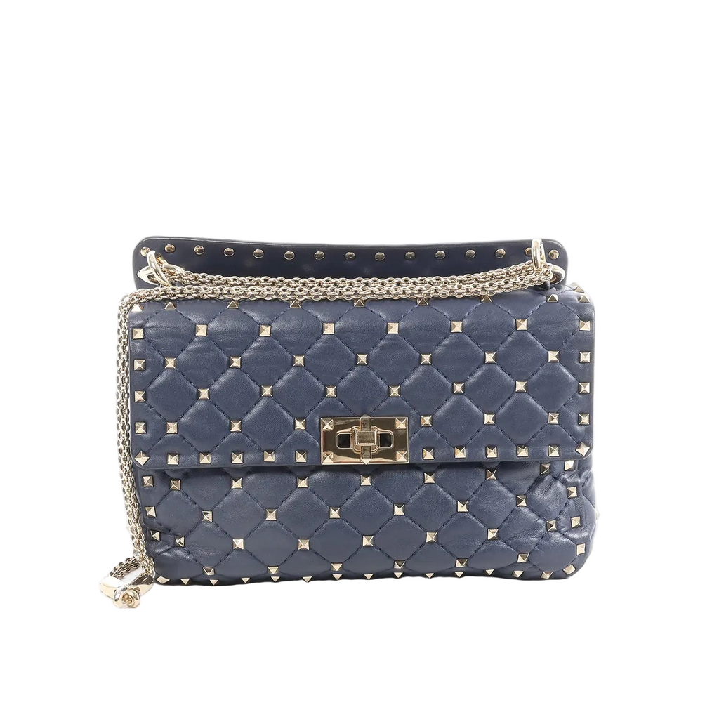 Navy Valentino Rockstud Spike quilted leather bag with pyramid studs, top handle, turn-lock closure, and gold-tone chain strap.