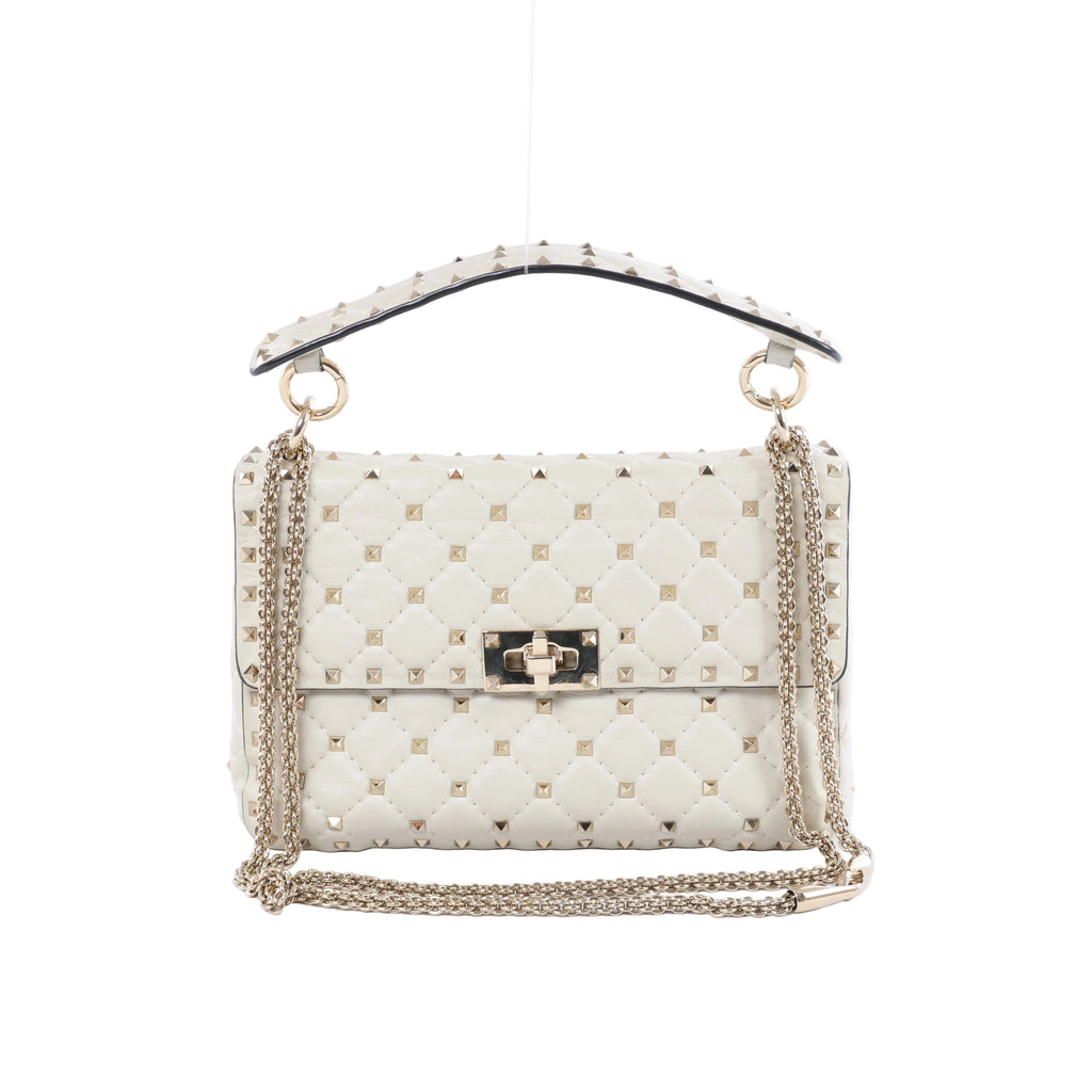 Valentino Garavani white quilted leather shoulder bag with gold-tone pyramid studs, studded top handle, chain strap and turn-lock closure.