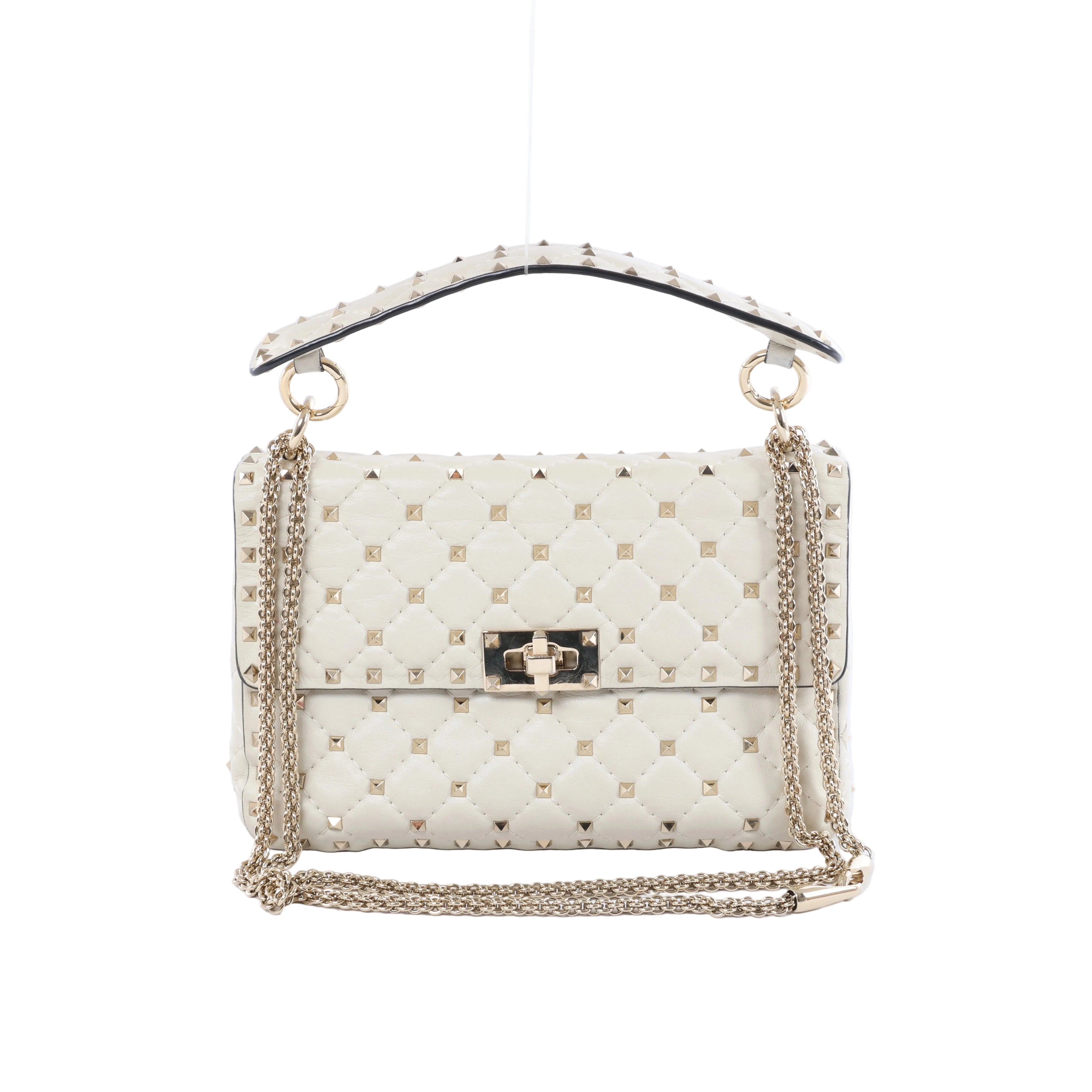 Valentino Garavani white quilted leather shoulder bag with gold-tone pyramid studs, studded top handle, chain strap and turn-lock closure.