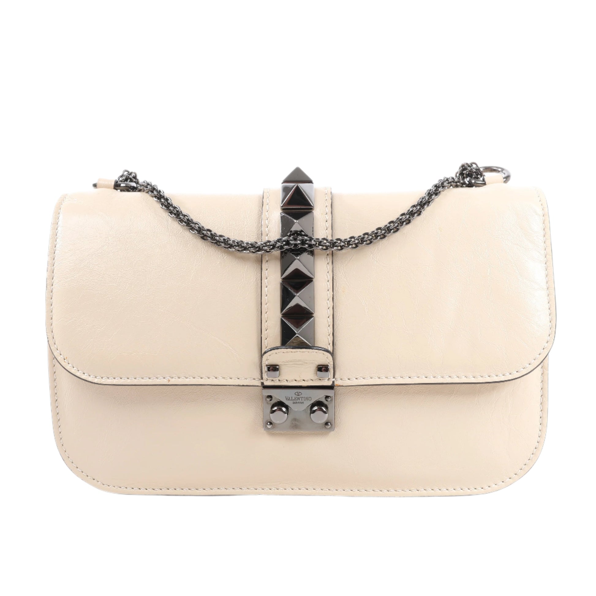Beige handbag with a decorative chain and clasp on a white background