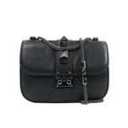 Valentino Rockstud Glam Lock shoulder bag in black grained leather with pyramid stud accents, flap closure with metal lock, and silver-tone chain strap against a white background.