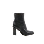Black Valentino Garavani leather ankle boot with chunky block heel and pyramid Rockstud trim along the top edge and sole welt, shown in side profile.