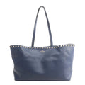 Valentino Garavani Rockstud shoulder bag in navy blue grained leather with gold-tone pyramid studs along the top edge and double shoulder straps on a white background.