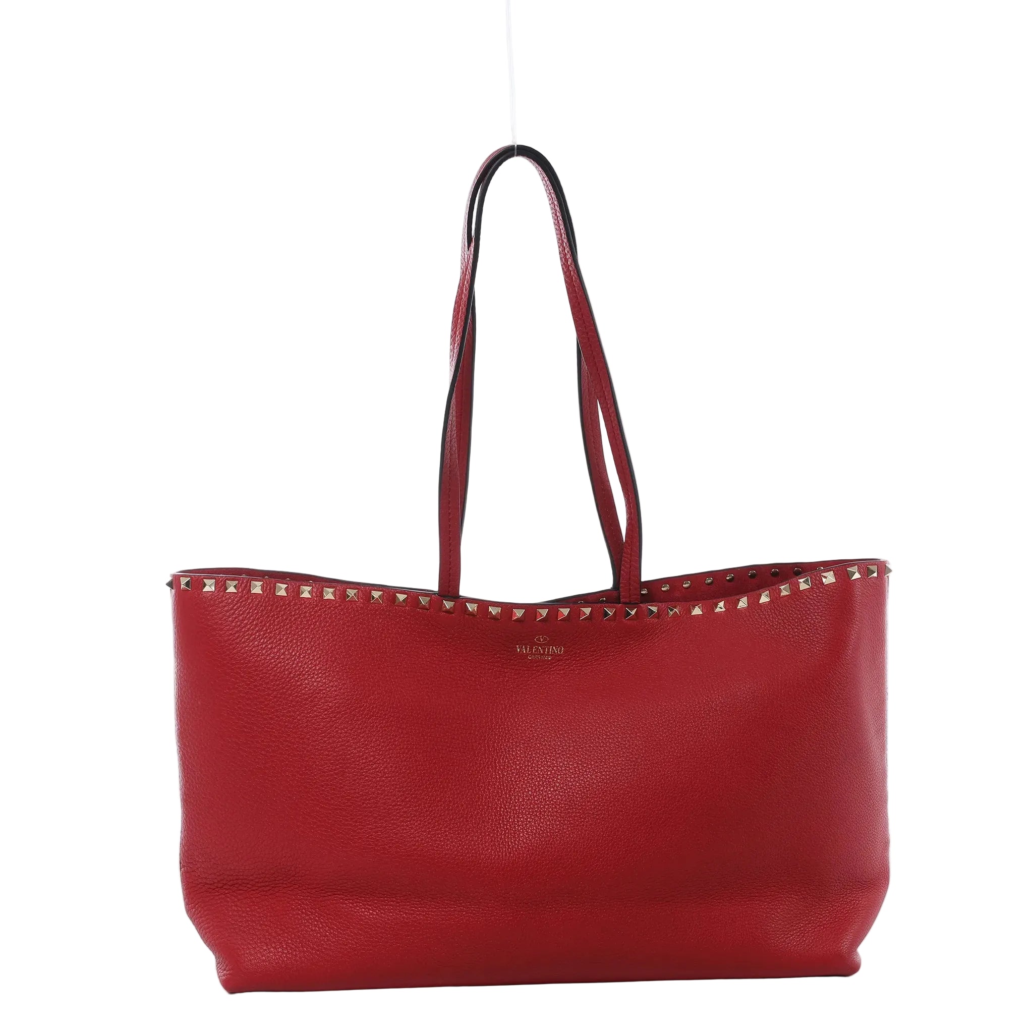 Valentino Garavani Rockstud red grained leather shoulder bag with slim shoulder straps, gold-tone stud trim, and structured open-top tote silhouette on white background.