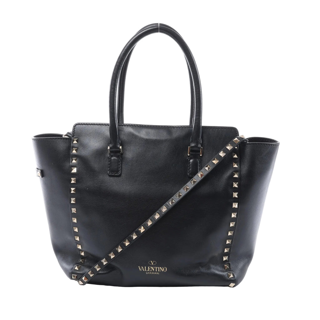 Valentino Garavani black leather handbag with pyramid stud trim, two top handles, detachable studded shoulder strap and gold logo.