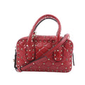 Valentino Rockstud handbag in red quilted leather with gold-tone pyramid studs, wrapped top handles and a detachable shoulder strap.