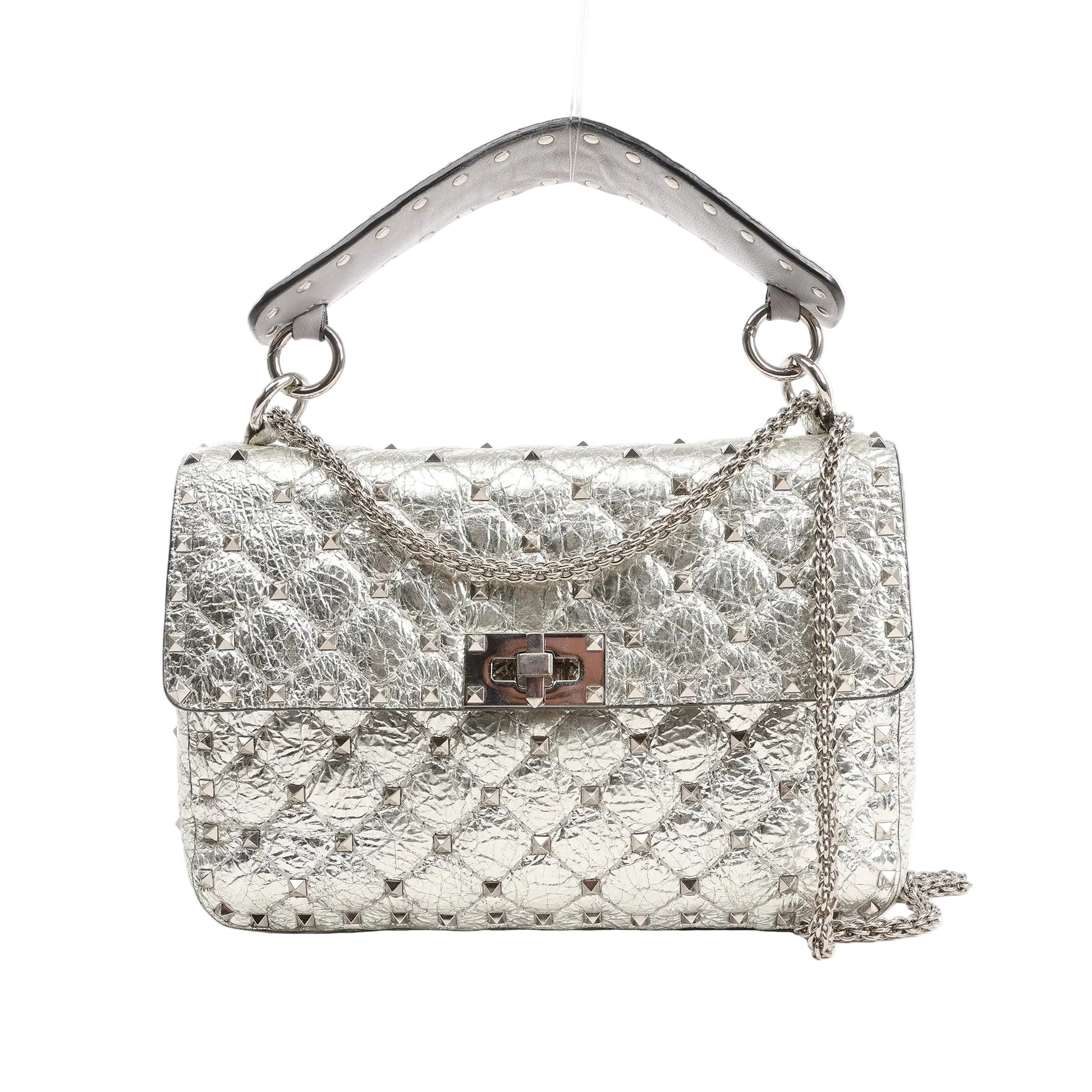 Valentino Garavani Rockstud Spike 2Way shoulder bag in metallic silver quilted leather, featuring pyramid stud detailing, a top handle, turn-lock closure, and silver chain strap, shown on a white background.