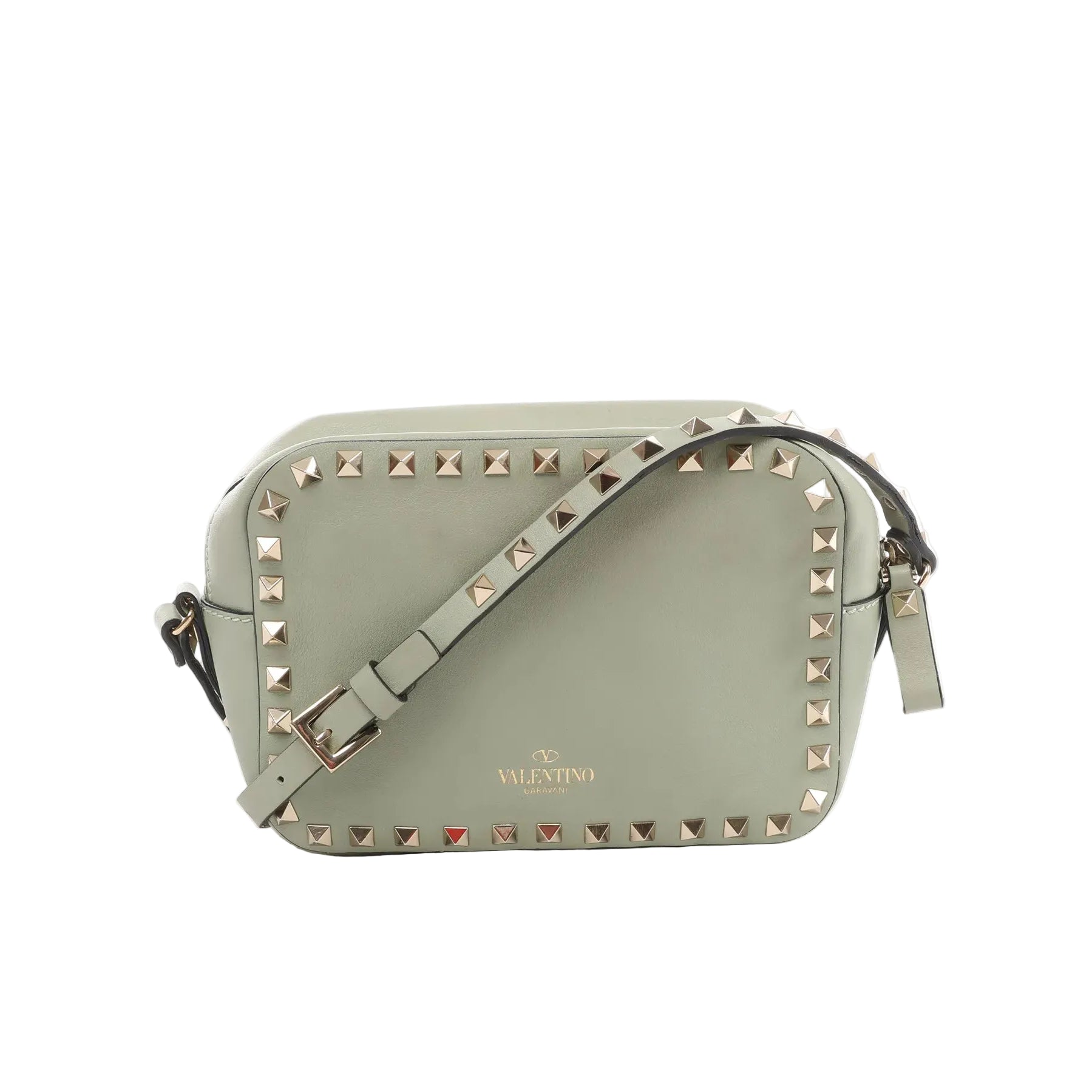Sage green leather Valentino Garavani crossbody bag with gold-tone pyramid studs around the edge, adjustable strap, and zip-top closure on a white background.