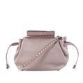Valentino Garavani Rockstud pink leather crossbody bag with pyramid stud trim, studded shoulder strap and drawstring sides.