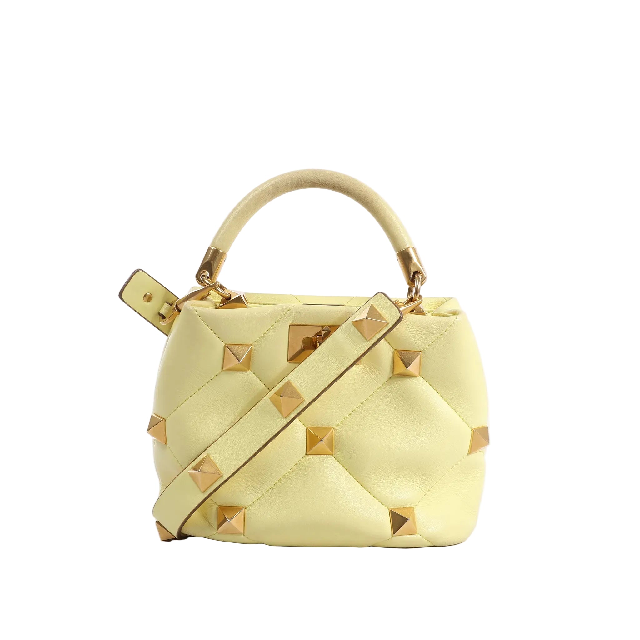 Valentino Garavani Roman Studs yellow quilted leather mini handbag with gold stud hardware, top handle, and matching shoulder strap on white background.