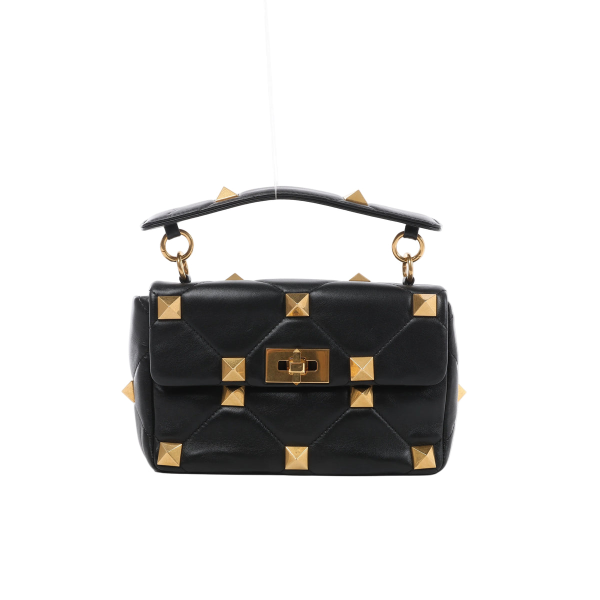 Front view of Valentino Garavani black quilted leather handbag with oversized gold-tone pyramid studs, a studded top handle and turn-lock flap closure.