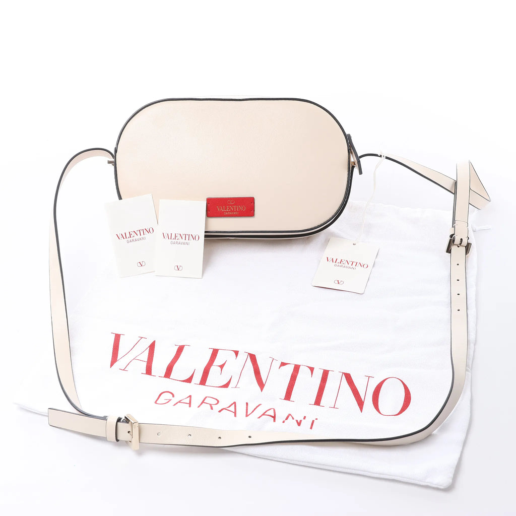 Valentino Garavani V logo Leather Crossbody Bag in Pink