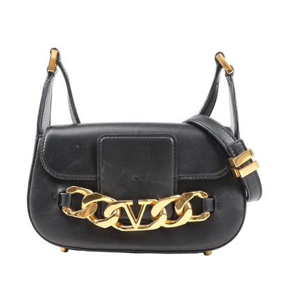 Front view of a Valentino Garavani VLogo shoulder bag in smooth black leather, featuring a gold-tone chain with VLogo emblem, structured silhouette, and adjustable leather strap.