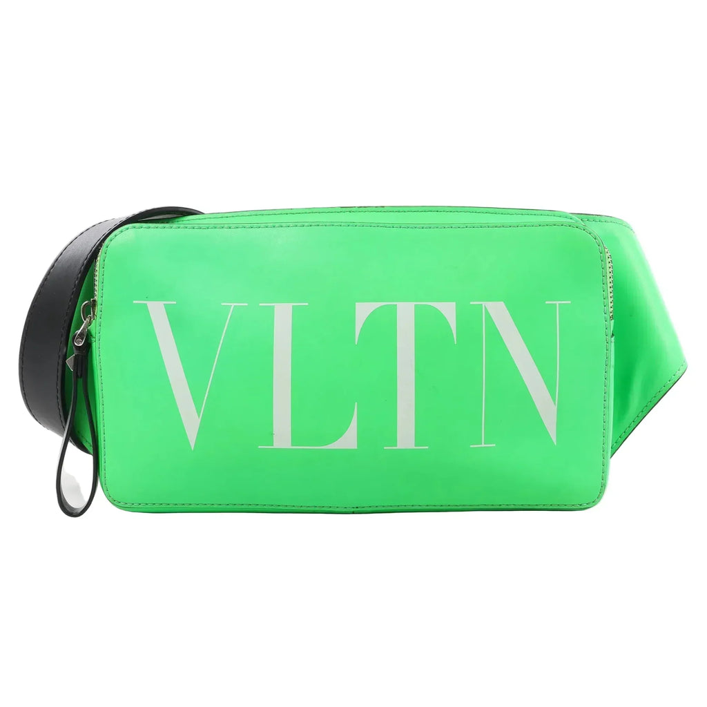 Valentino Garavani VLTN Leather Belt Bag in bright green with large white VLTN logo on the front, black adjustable strap, and zip closure, displayed against a white background.