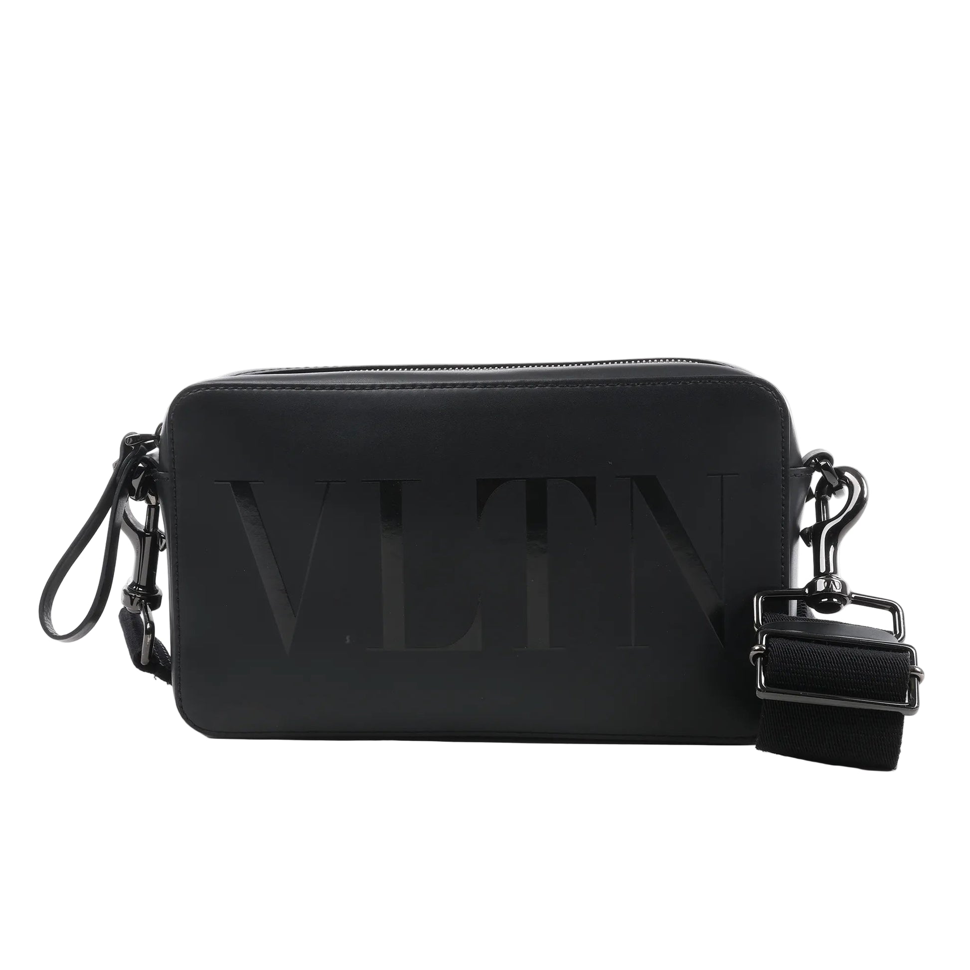 Valentino Garavani VLTN black leather shoulder bag with embossed logo, zip closure, detachable strap, and rectangular structured design against a white background.