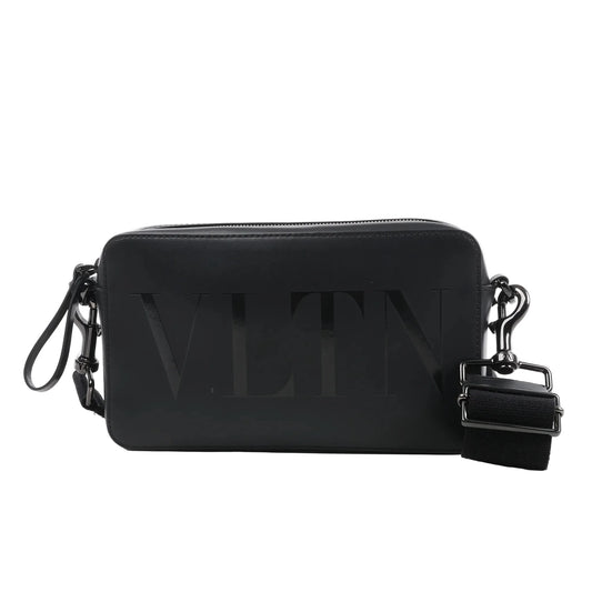 Valentino Garavani VLTN black leather shoulder bag with embossed logo, zip closure, detachable strap, and rectangular structured design against a white background.