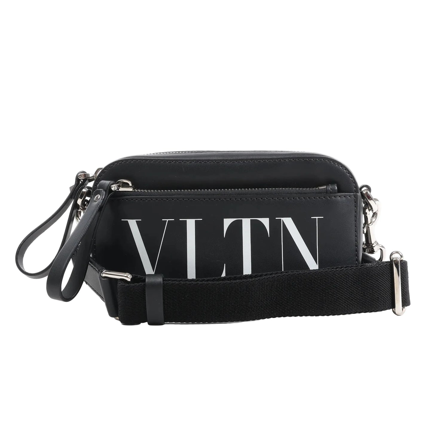 Front view of the Valentino Garavani VLTN Leather Shoulder Bag in black, featuring smooth leather exterior, bold white VLTN logo print, front zip pocket, detachable black fabric strap, and silver-tone hardware, displayed against a white background.