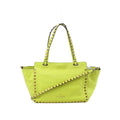Valentino Garavani Rockstud yellow leather 2-way handbag with gold-tone pyramid studs, double top handles, and detachable shoulder strap on white background
