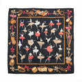 Black Hermès Carré 90 scarf laid flat with red and white ballerinas, musical sheets, pointe shoes and colourful ballet-themed border motifs.