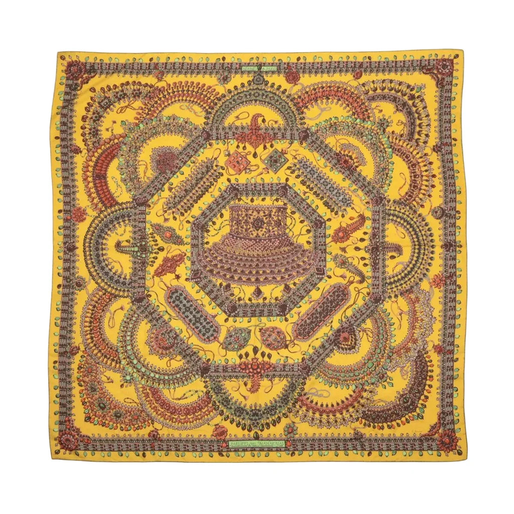 Hermès Parures des Maharajas Carré Géant scarf in golden yellow with intricate multicolour jewel and ornamental motifs.