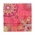 Red and pink Hermès Carré 90 silk scarf laid flat with multicolour floral, foliage and abstract patterned motifs.