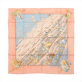 Pink and pale blue Hermès Carré 90 silk scarf laid flat with an illustrated Lake Inlé floating market scene of boats and figures.