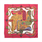 Hermès Carré 90 red silk scarf with white center, colorful ornate saddle and bridle motifs in gold, green, blue and pink.