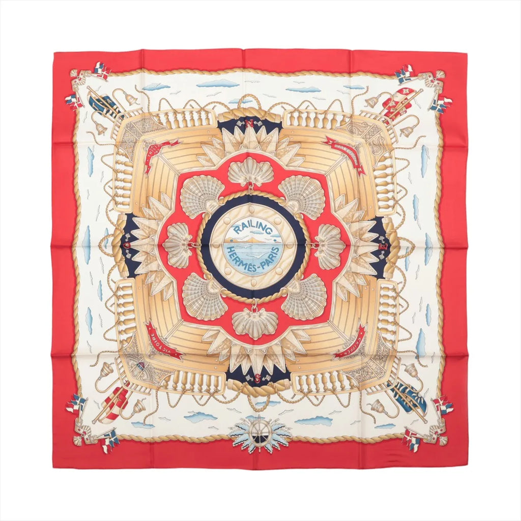 Hermès Carré 90 Railing silk scarf with red border, cream center, gold shell motifs, ropes, railings and navy nautical details.