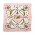 Hermès Carré 90 Springs pink silk scarf with cream panels, gold saddles, gray carriage wheels and symmetrical equestrian motifs.