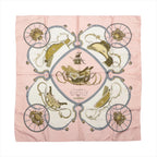 Hermès Carré 90 Springs pink silk scarf with cream panels, gold saddles, gray carriage wheels and symmetrical equestrian motifs.