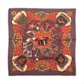 Hermès Carré 90 La Magie silk scarf in brown and red with rabbit in magician’s hat, playing cards, stars, birds and ornate gold motifs.