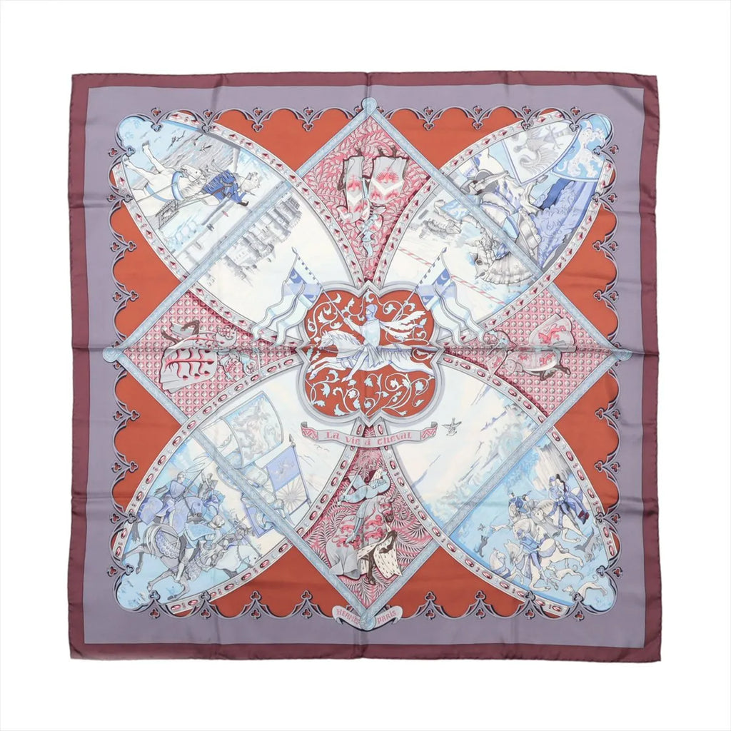 Hermès Carré 90 La Vie à Cheval silk scarf with brown border, red panels, pale blue equestrian scenes and sweeping harness motifs.