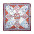Hermès Carré 90 La Vie à Cheval silk scarf with brown border, red panels, pale blue equestrian scenes and sweeping harness motifs.